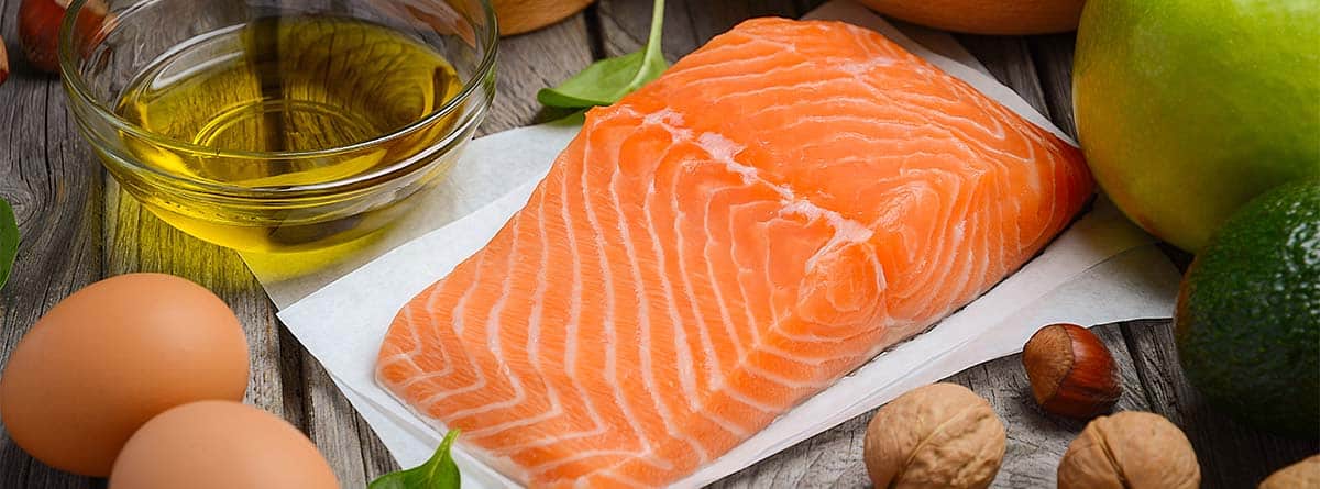 Bodegón de comida saludable: salmón, fruta y semillas